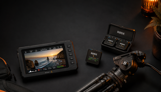 Videoguys Australia EOFY 2026 sale — Blackmagic Design monitor recorder, Rode Wireless GO microphone system and Sachtler carbon fibre tripod head arranged on a dark surface with warm ambient lighting